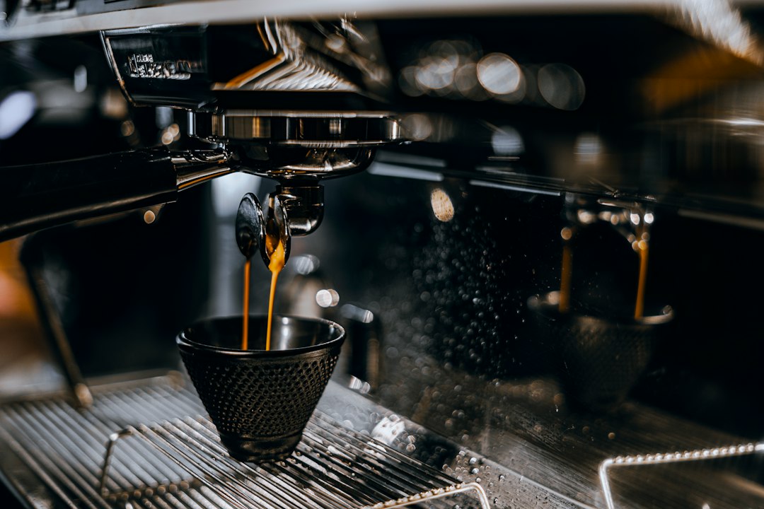 Coffee pouring into a machine illustrating Baratza Encore vs Encore ESP.