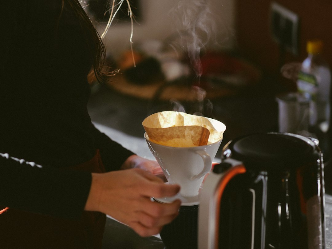Coffee maker and mugs on a counter, illustrating best coffee makers under two hundred dollars.