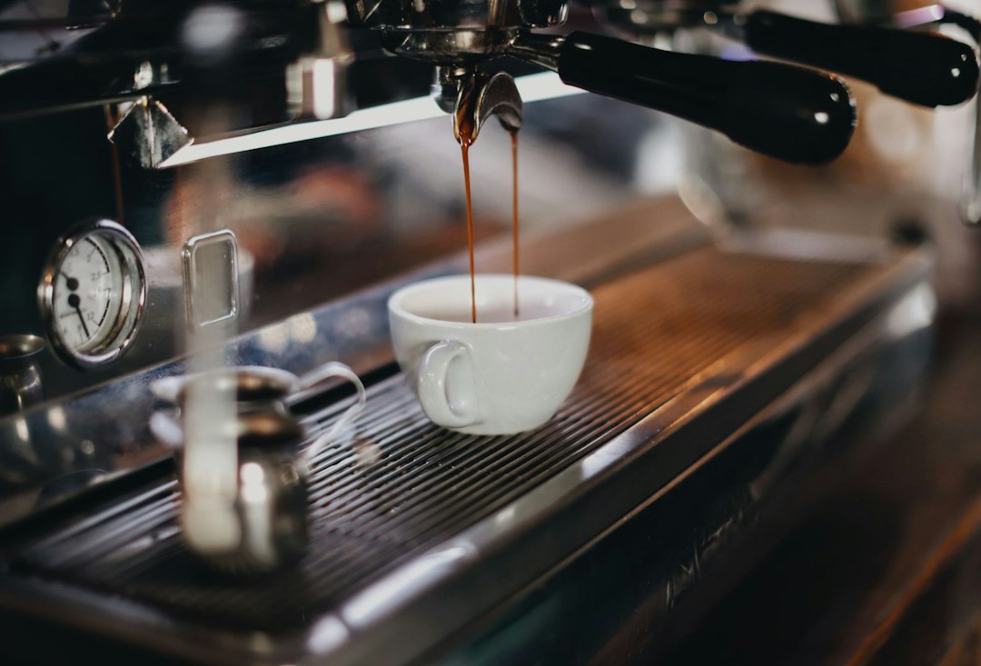 Espresso cup beside a home machine, illustrating beginner-friendly espresso machines.