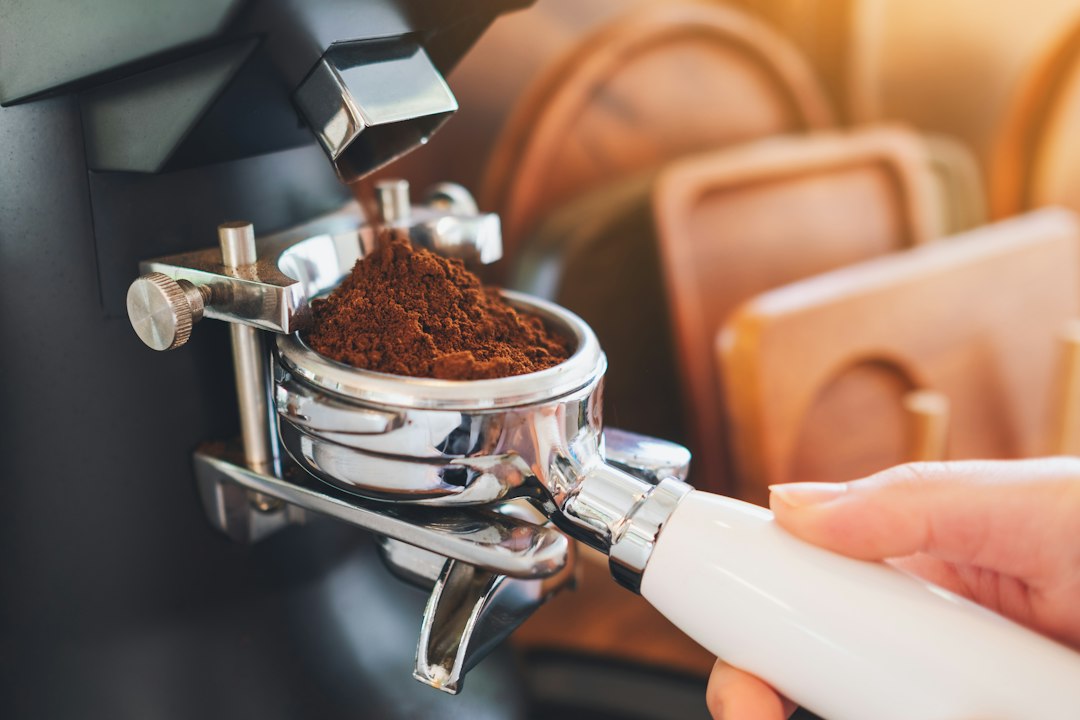 Ground coffee in a portafilter illustrating Breville Bambino vs Bambino Plus.