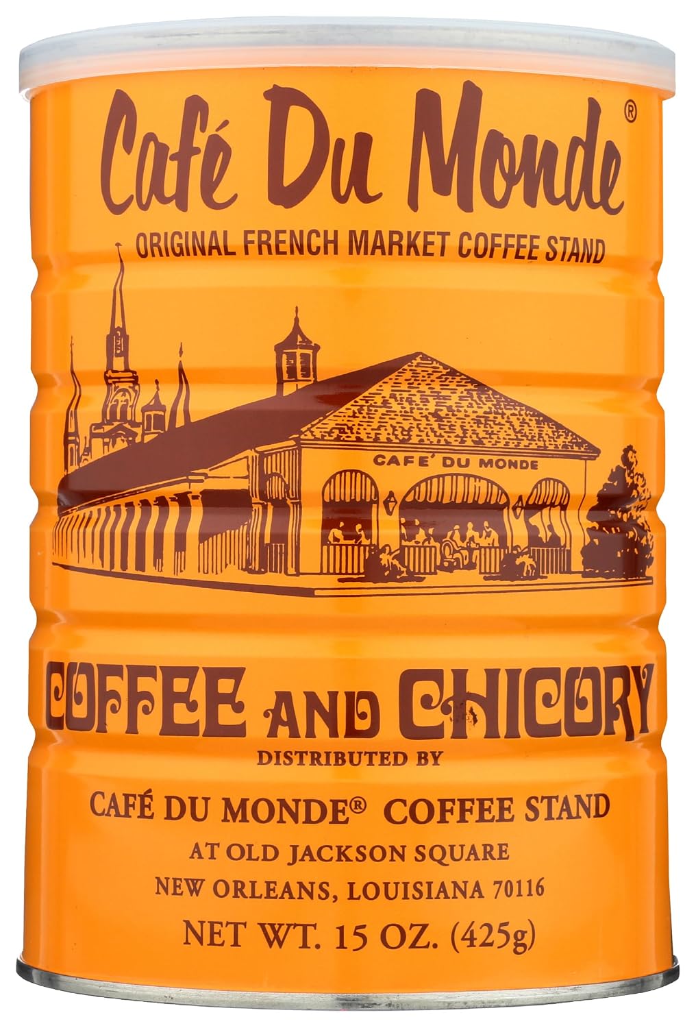 A chicory iced coffee in a white mug beside powdered-sugar beignets, a cold brew pitcher, and ground coffee on a French Quarter balcony table.