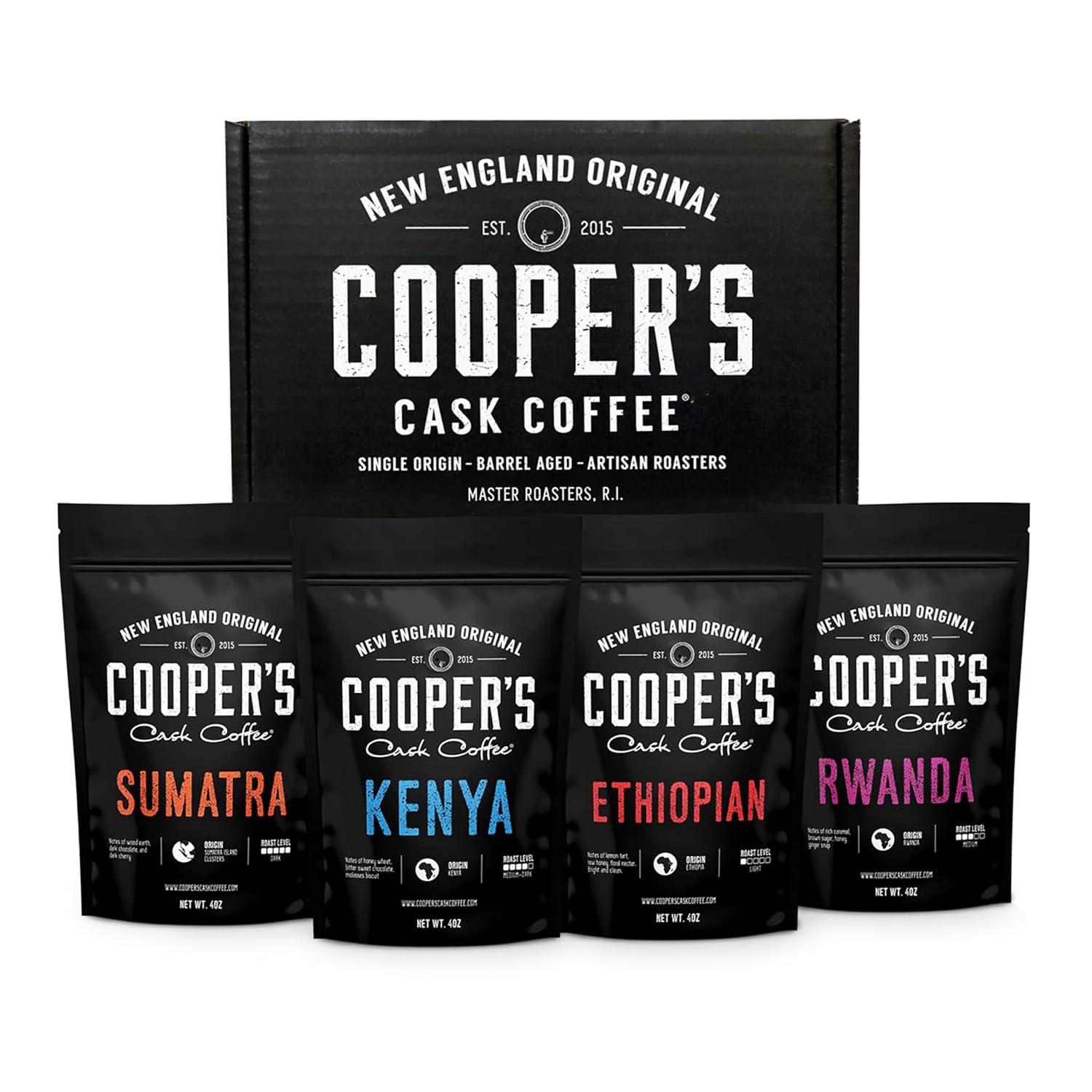 Three small cups of black coffee on a wooden board with dishes of light, medium, and dark roasted beans, sample bags in a gift box, and a notebook, illustrating a single origin sampler for tasting black coffee.