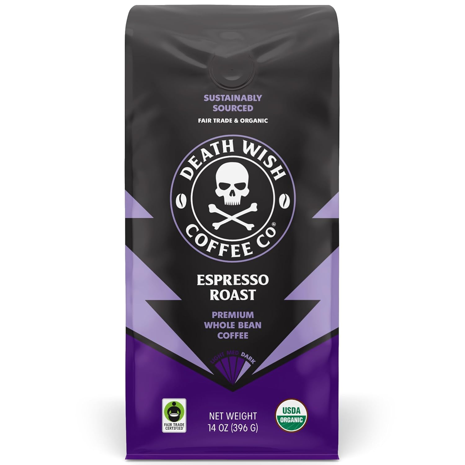 A black mug of steaming dark coffee beside a moka pot, glossy dark-roast beans, baker's chocolate, and dark cherries on a wood table before dawn, illustrating bold dark roast coffee beans.