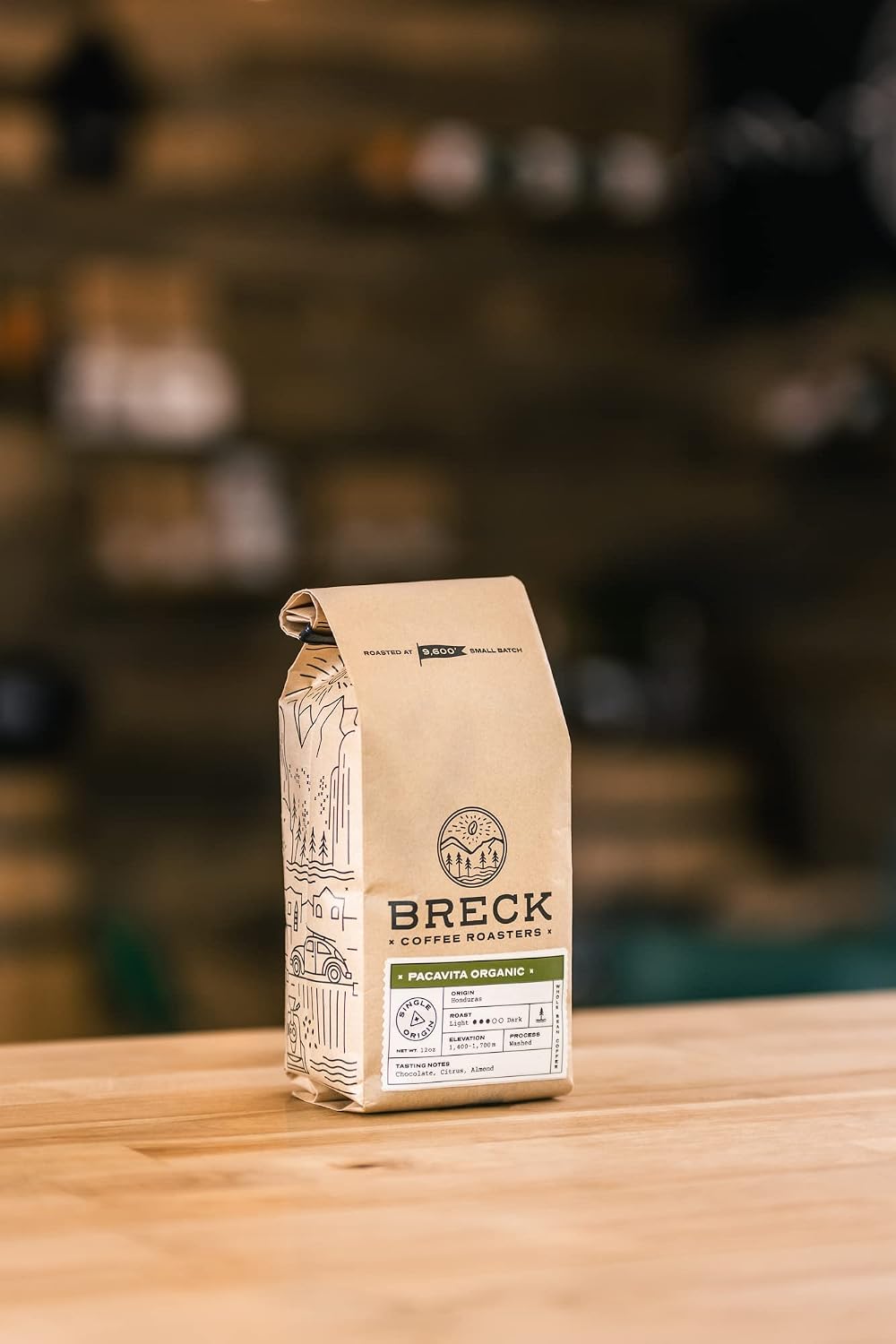 A frothy chocolate-hazelnut latte dusted with cocoa beside a jar of hazelnut spread and hazelnuts on a cozy table, a comforting setting for Honduran coffee.