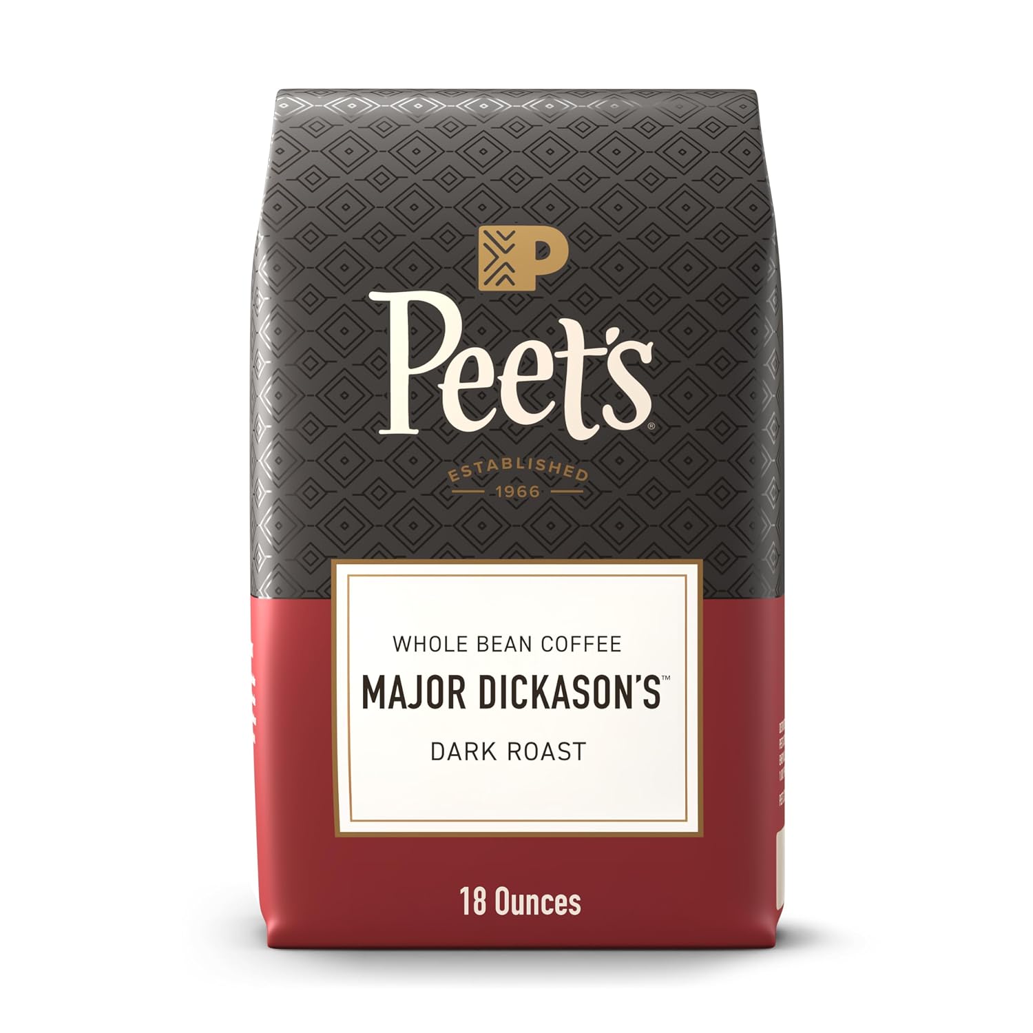 Unlabeled black bag of dark roast beans beside a mug of black coffee on a wooden kitchen counter.