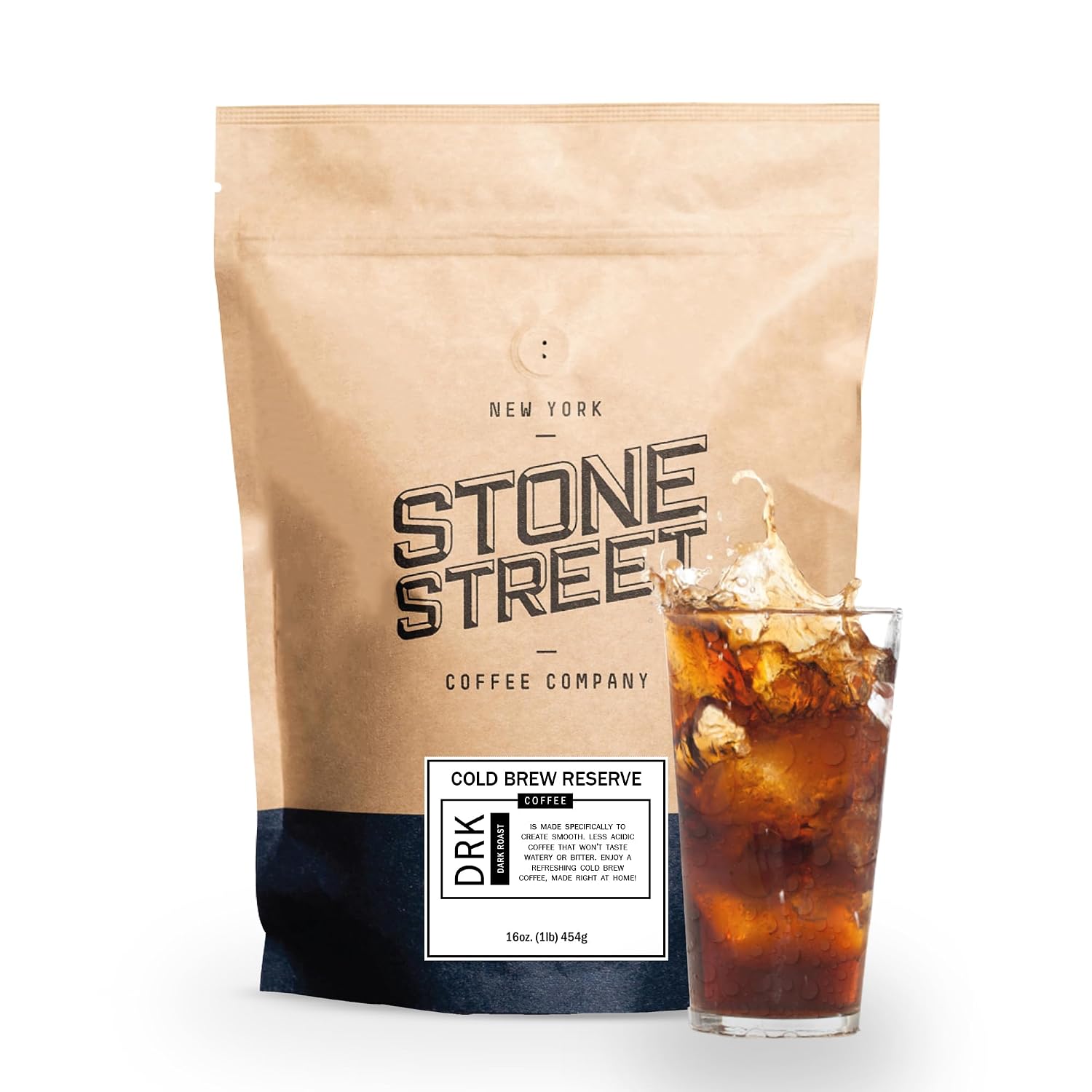 A honey cinnamon iced latte in a stoneware tumbler beside a cold brew pitcher, coarse ground coffee, honey, and cinnamon sticks on an oak counter.